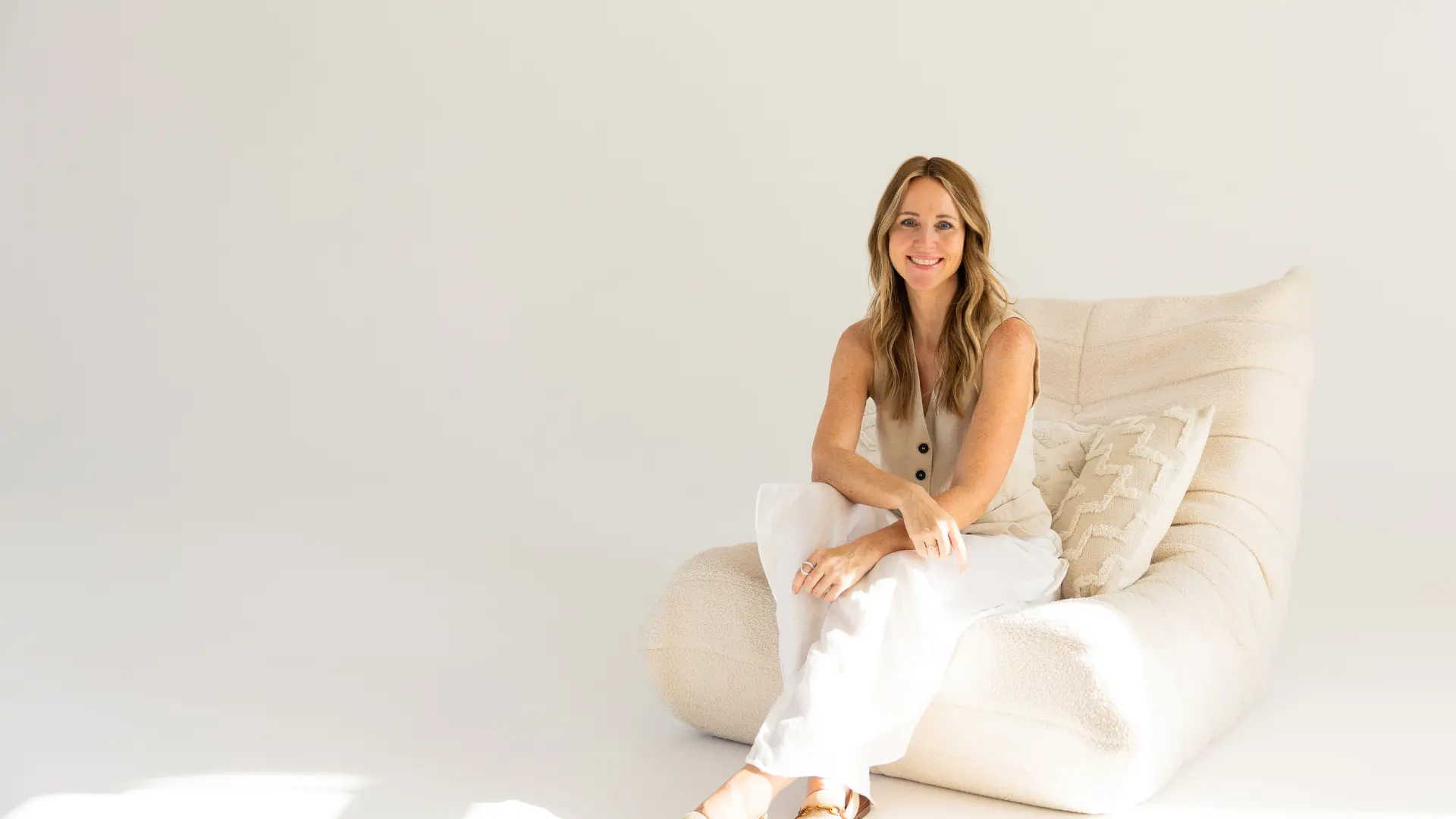 Carina sitzt im Sofa mit Blick in die Kamera